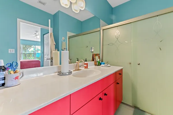 a bathroom with a sink vanity tub and shower