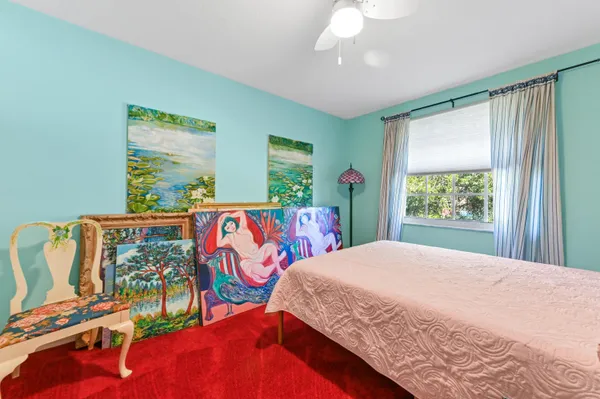 a bedroom with a bed and a painting on the wall