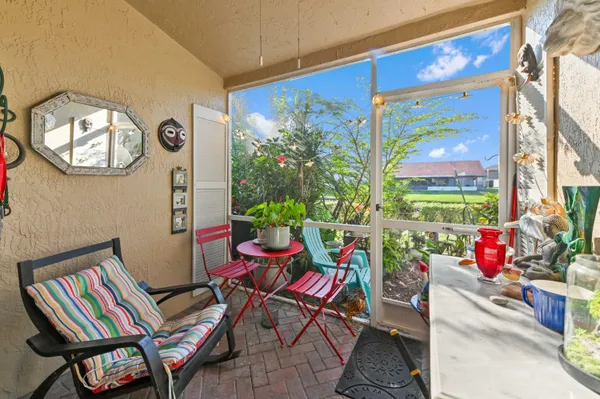 a view of a house with backyard and sitting area