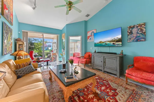 a living room with furniture a large window and a flat screen tv