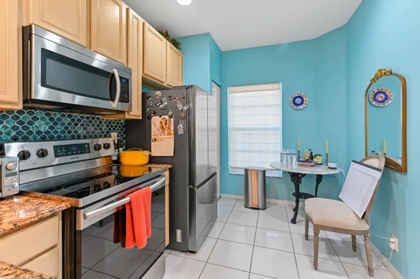 a kitchen with stainless steel appliances a stove microwave and cabinets
