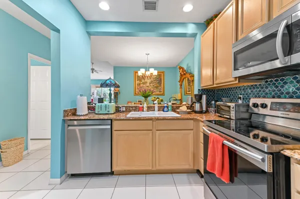 a kitchen with a sink cabinets and appliances