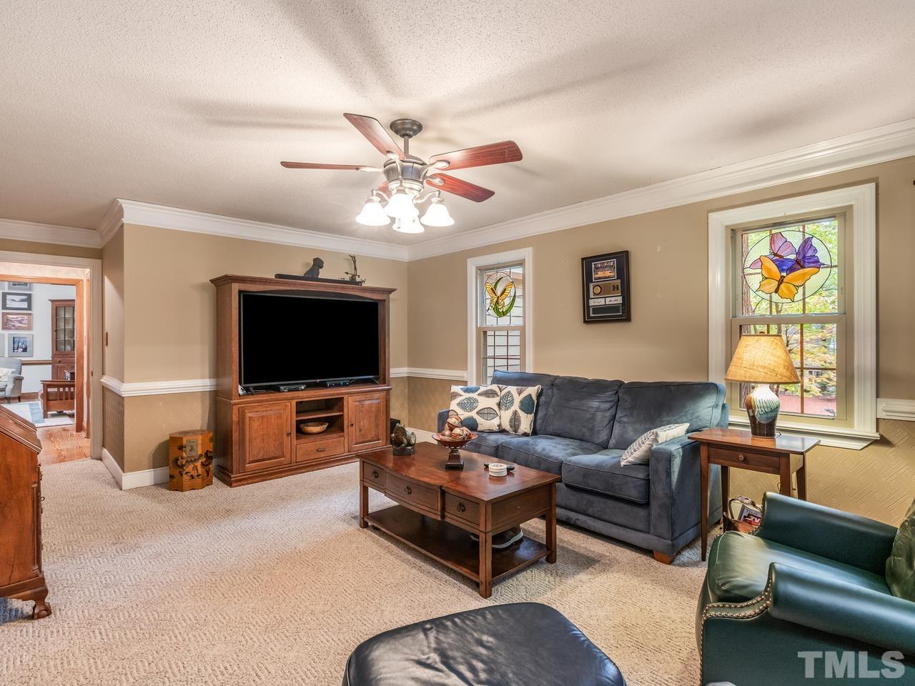 2003 Parliament Place Apex, NC 27502 - Photo 13 of 24 a living room with furniture and a flat screen tv