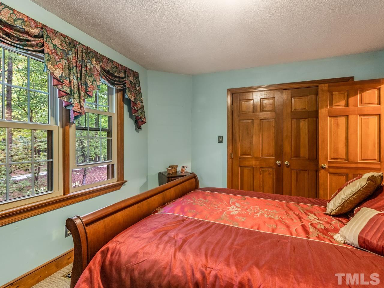 2003 Parliament Place Apex, NC 27502 - Photo 16 of 24 a bed sitting in a bedroom next to a window