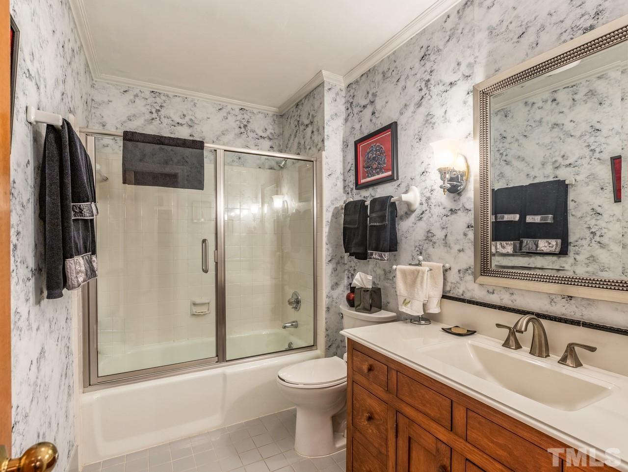 2003 Parliament Place Apex, NC 27502 - Photo 17 of 24 a bathroom with a sink toilet and shower