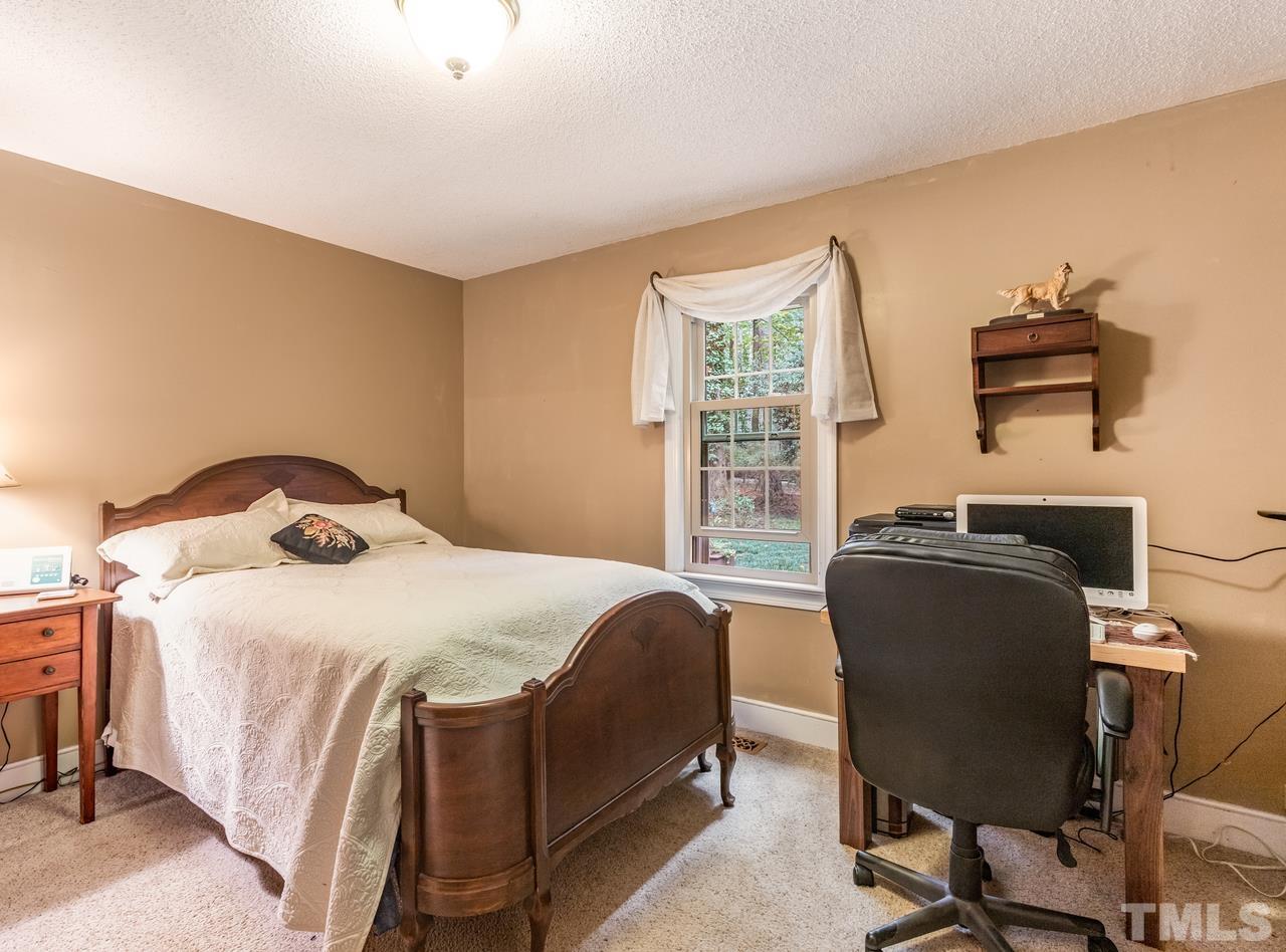 2003 Parliament Place Apex, NC 27502 - Photo 18 of 24 a bedroom with a bed and a desk