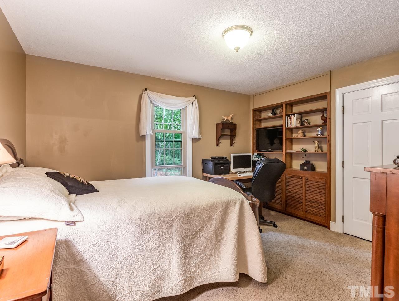 2003 Parliament Place Apex, NC 27502 - Photo 19 of 24 a bedroom with a bed and furniture
