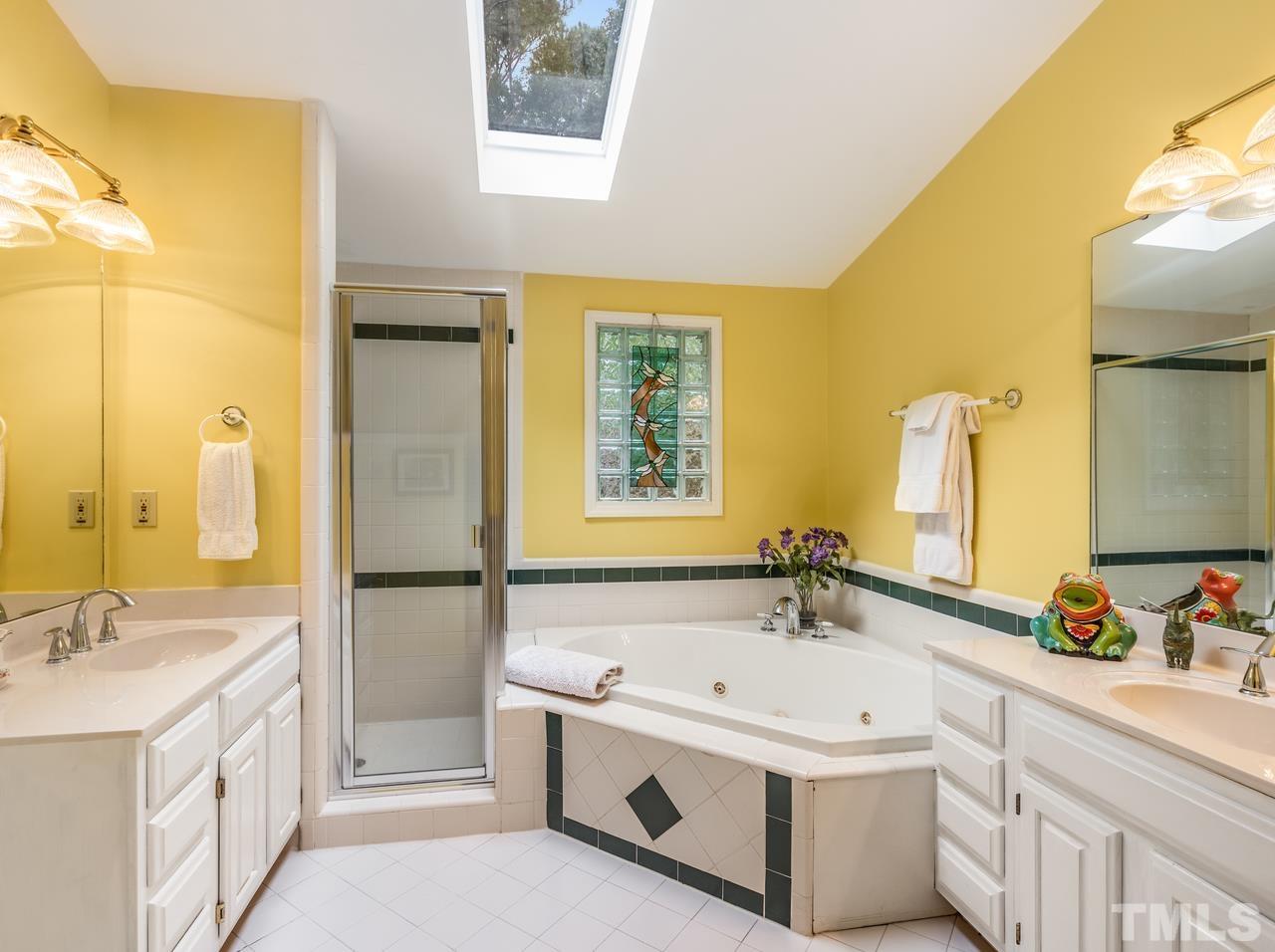 2003 Parliament Place Apex, NC 27502 - Photo 21 of 24 a bathroom with a tub sink and mirror