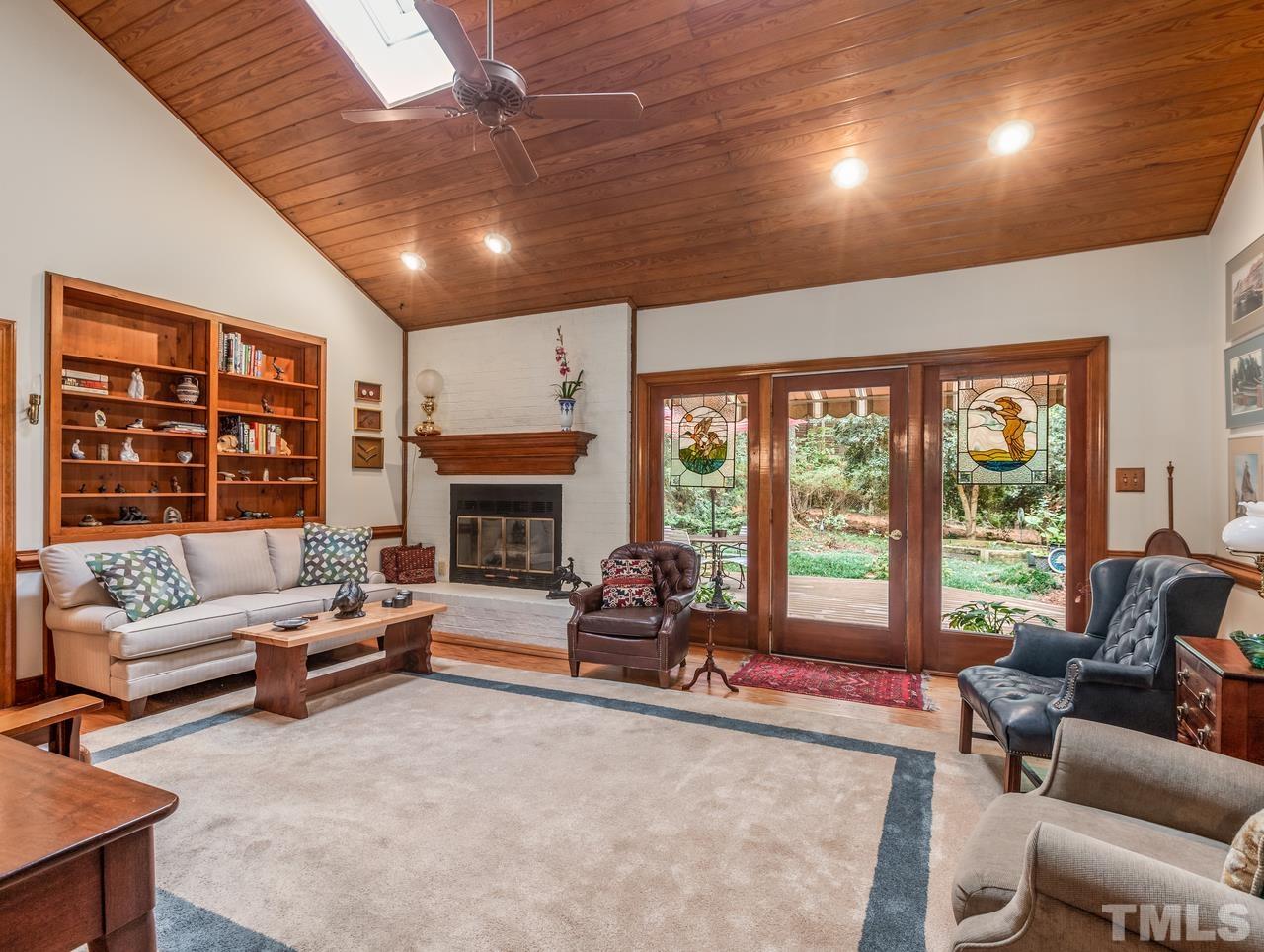 2003 Parliament Place Apex, NC 27502 - Photo 5 of 24 a living room with furniture large windows and a fireplace