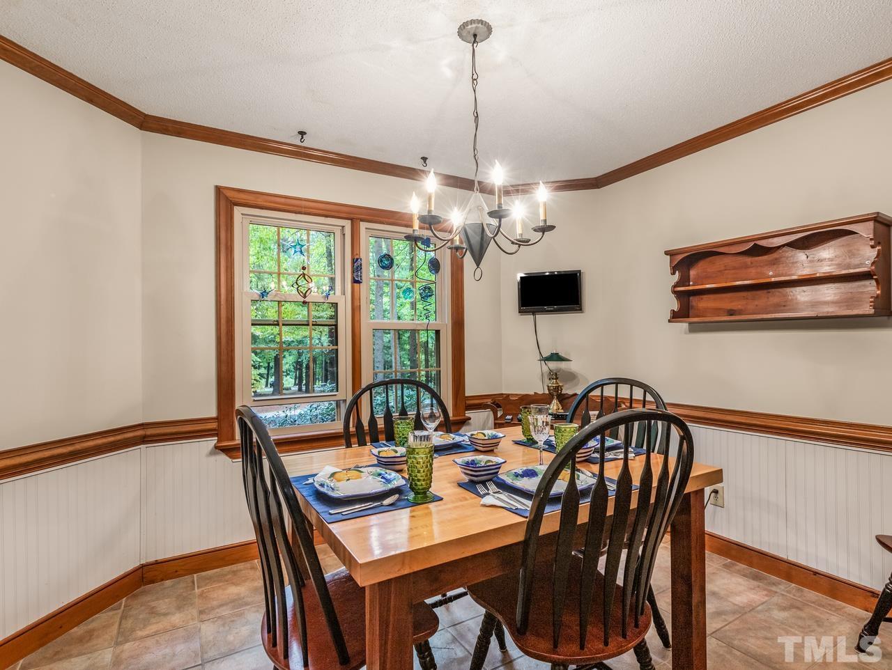 2003 Parliament Place Apex, NC 27502 - Photo 8 of 24 a view of a dining room with furniture window and outside view