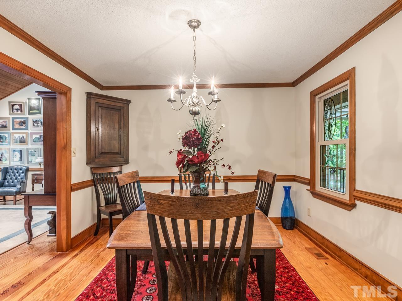 2003 Parliament Place Apex, NC 27502 - Photo 10 of 24 a view of a dining room with furniture window and wooden floor