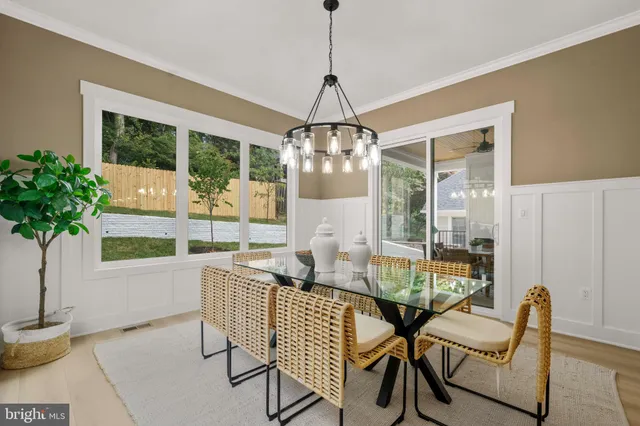 a dining room with furniture and wooden floor