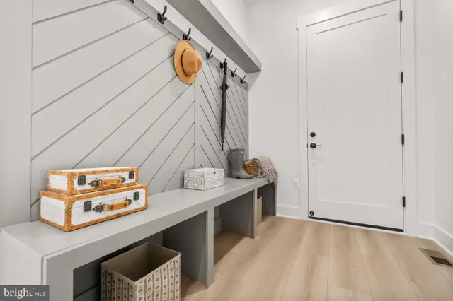 a bedroom with a bed wooden floor and window