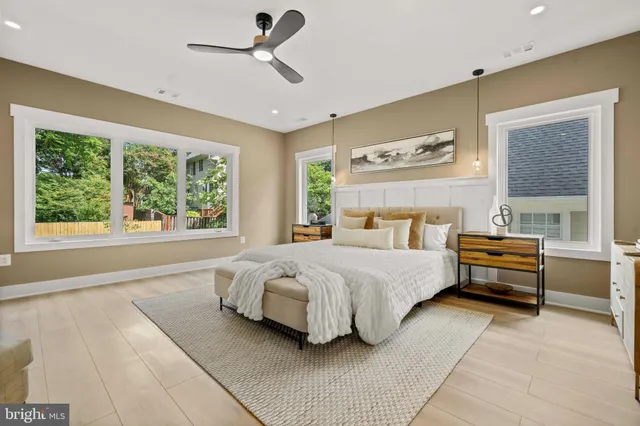 a spacious bedroom with a bed and a large mirror