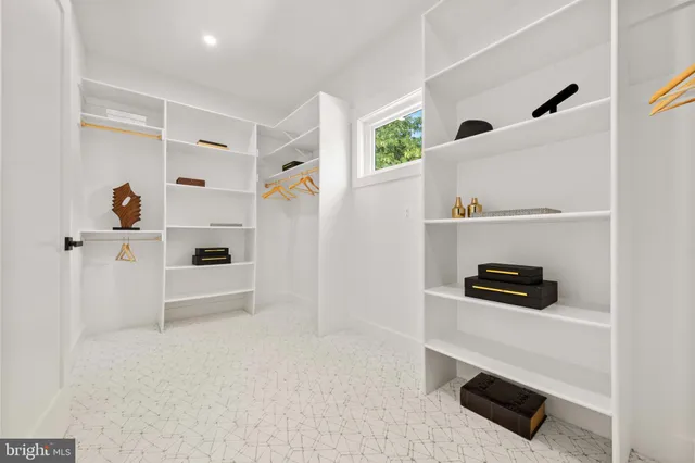 a kitchen with stainless steel appliances white cabinets and a sink