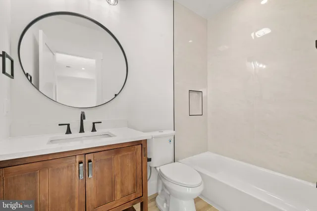 a spacious bedroom with a bed furniture and ceiling fan