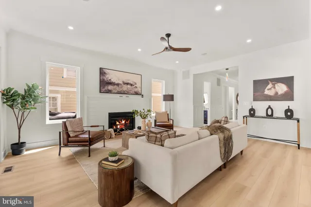 a living room with furniture large window and a fireplace