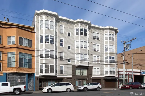 a couple of cars parked in front of a building