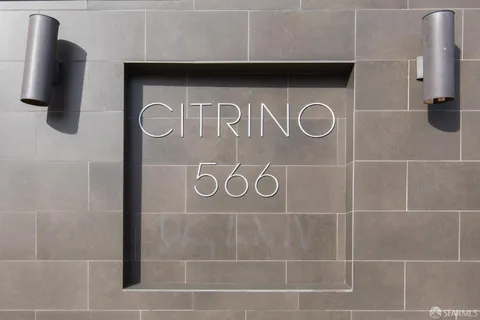 a view of a room with stainless steel appliances granite countertop lots of white wooden cabinets