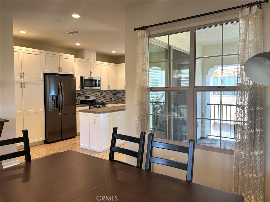 104 Briarberry Irvine, CA 92618 - Photo 11 of 27 a kitchen with stainless steel appliances granite countertop a refrigerator and a stove top oven