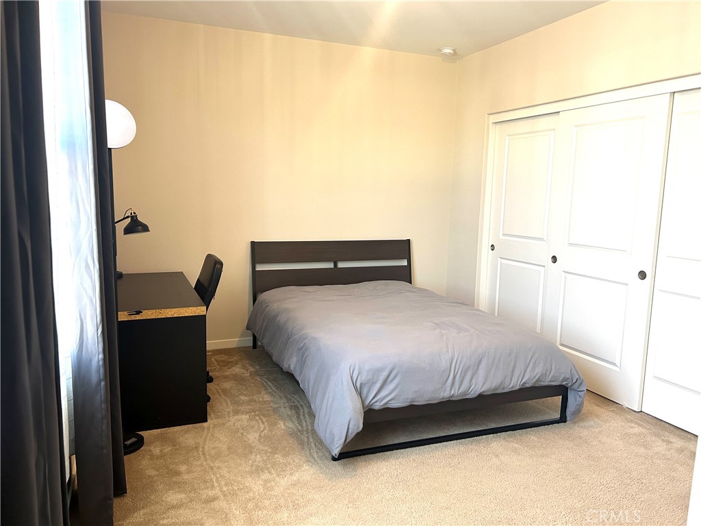 104 Briarberry Irvine, CA 92618 - Photo 18 of 27 a bedroom with a bed and wooden floor