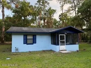a house that has a tree in front of the house