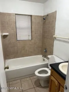 a bathroom with a toilet a sink and bathtub