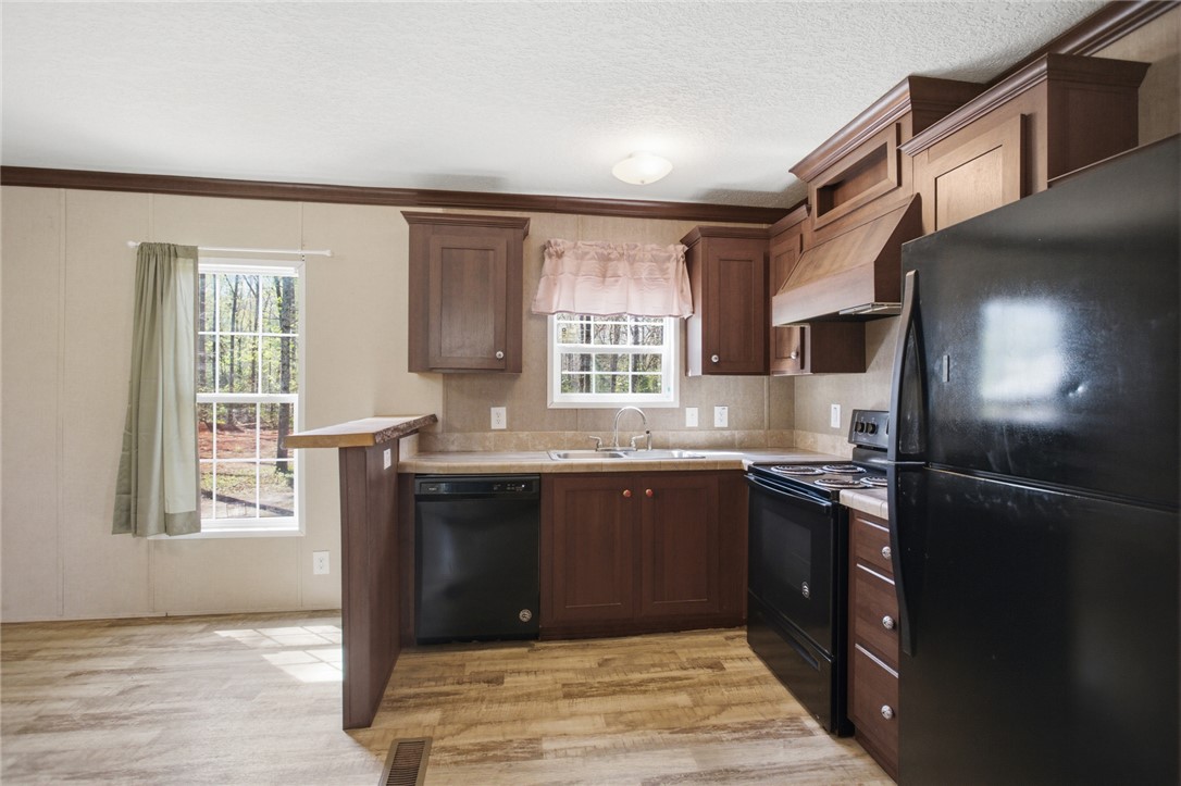 289 Bauknight Road Mountain Rest, SC 29664 - Photo 13 of 36 This functional kitchen features dark wood cabinetry, durable flooring, and ample natural light.