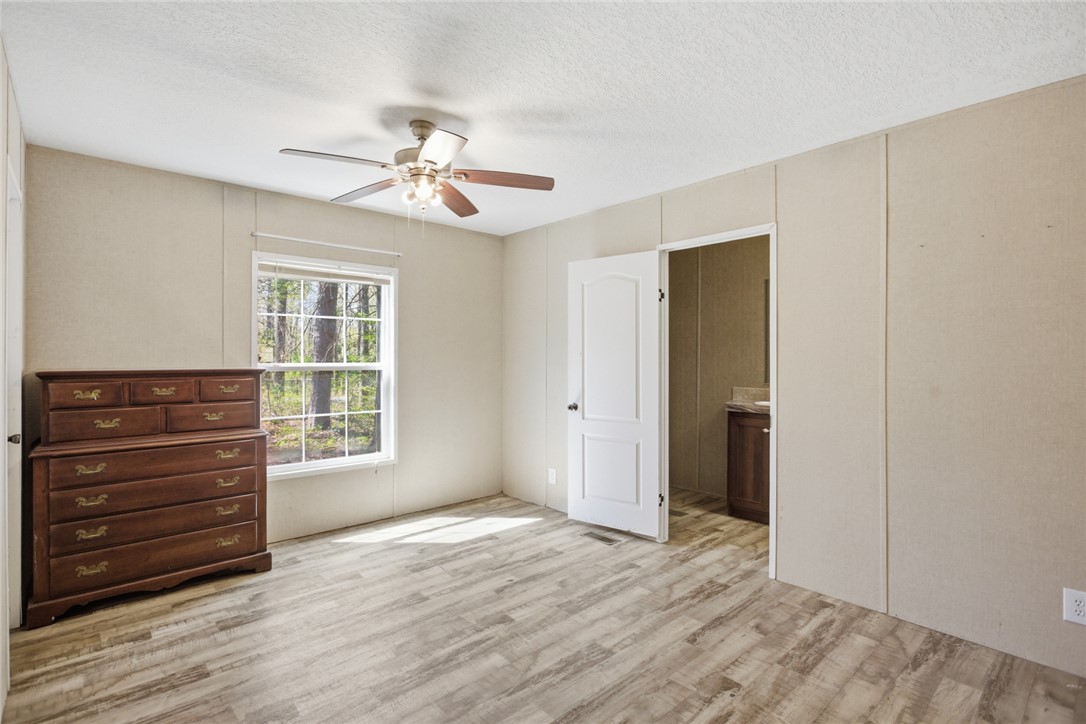 289 Bauknight Road Mountain Rest, SC 29664 - Photo 16 of 36 This airy bedroom offers ample natural light and direct access to an ensuite bathroom.