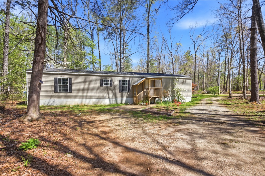 289 Bauknight Road Mountain Rest, SC 29664 - Photo 3 of 36 This secluded residence offers a peaceful retreat nestled amidst mature trees and a tranquil natural setting.