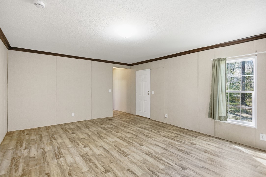 289 Bauknight Road Mountain Rest, SC 29664 - Photo 7 of 36 This bright living space features durable flooring and a view of lush greenery.