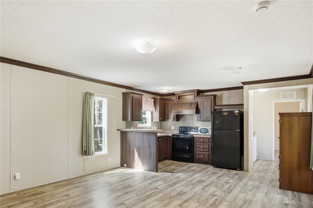 289 Bauknight Road Mountain Rest, SC 29664 - Photo 8 of 36 This inviting space combines a cozy kitchen with a relaxed living area, perfect for everyday living.