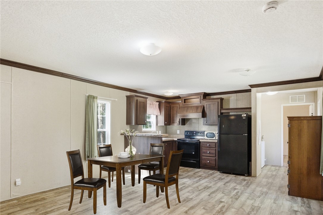 289 Bauknight Road Mountain Rest, SC 29664 - Photo 9 of 36 Bright and inviting kitchen and dining area with classic cabinetry and durable flooring.