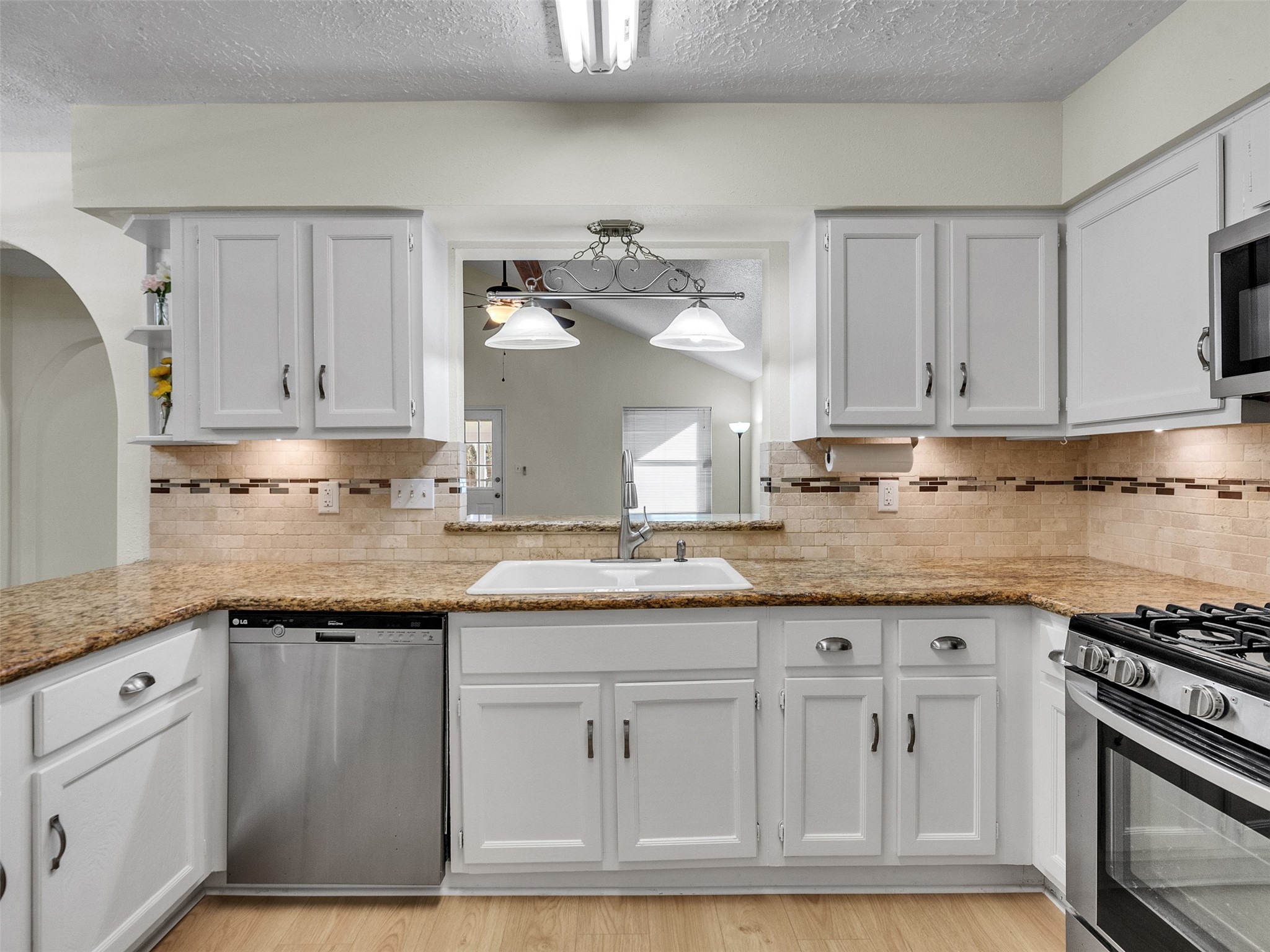 32 Sarita Road Angleton, TX 77515 - Photo 15 of 25 a kitchen with granite countertop white cabinets and a stainless steel appliances