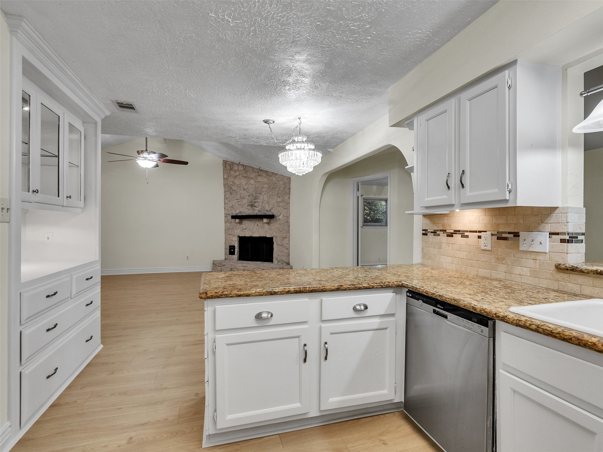 32 Sarita Road Angleton, TX 77515 - Photo 16 of 25 a kitchen with granite countertop white cabinets and white appliances