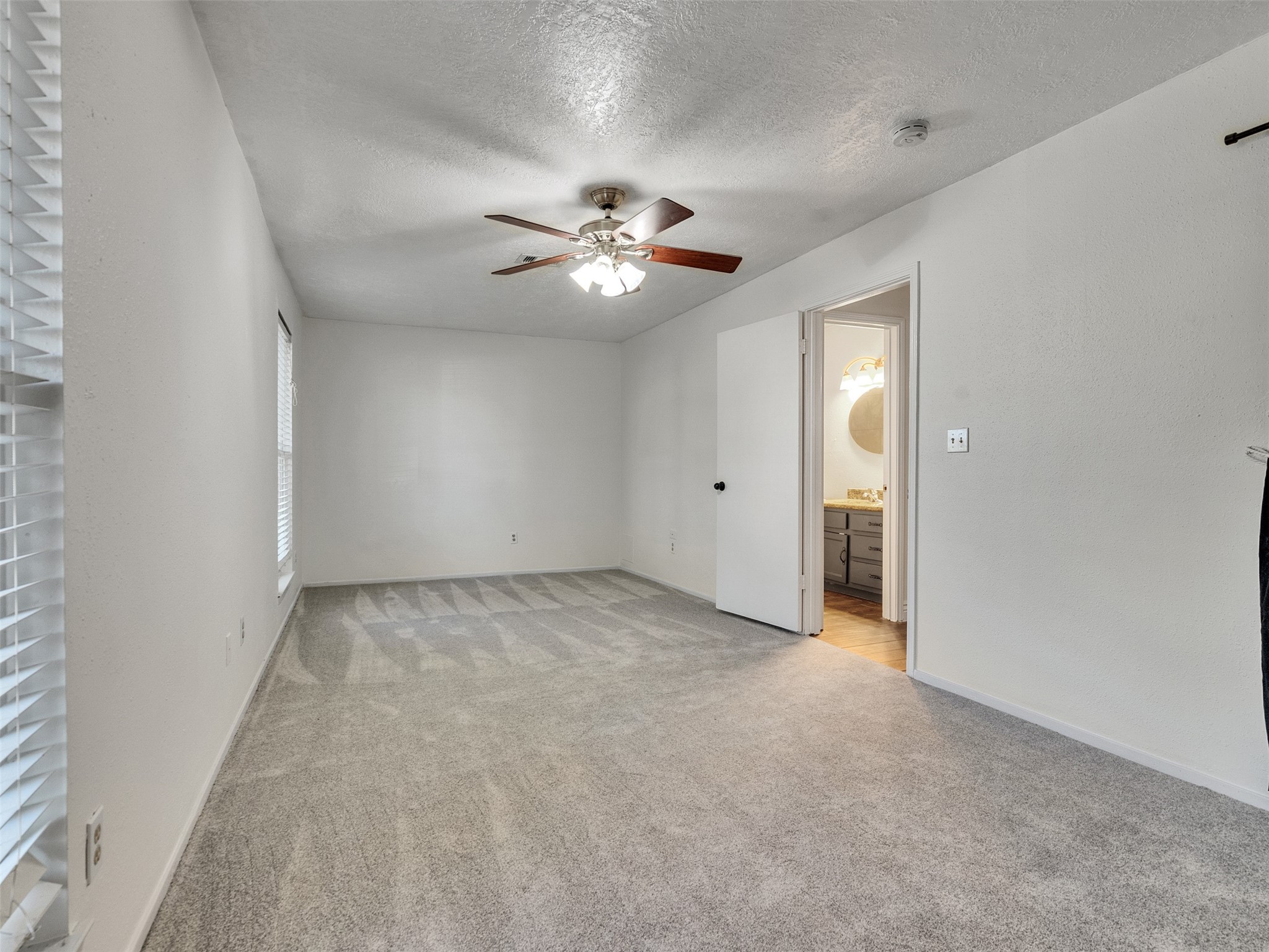 32 Sarita Road Angleton, TX 77515 - Photo 9 of 25 an empty room with chandelier fan and windows