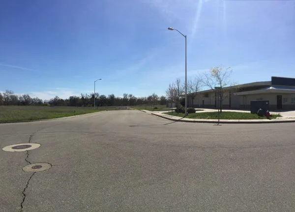 a view of a street with a building in the background