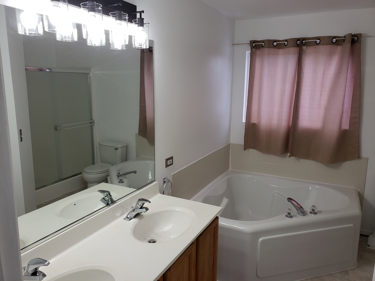 334 Spring Valley Way Round Lake, IL 60073 - Photo 18 of 26 a bathroom with a sink a mirror and shower