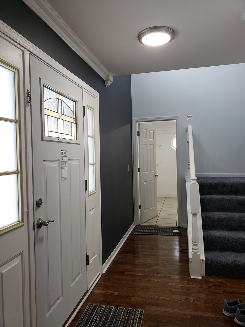334 Spring Valley Way Round Lake, IL 60073 - Photo 3 of 26 a view of entryway with wooden floor and stairs