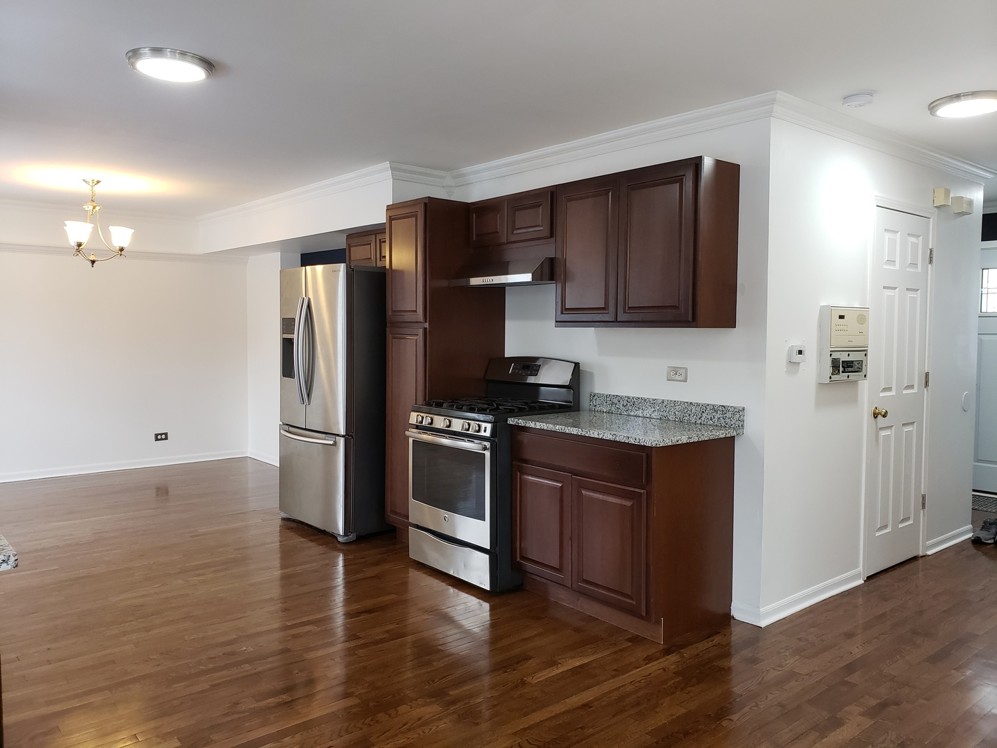 334 Spring Valley Way Round Lake, IL 60073 - Photo 6 of 26 a kitchen with granite countertop a refrigerator and a stove top oven