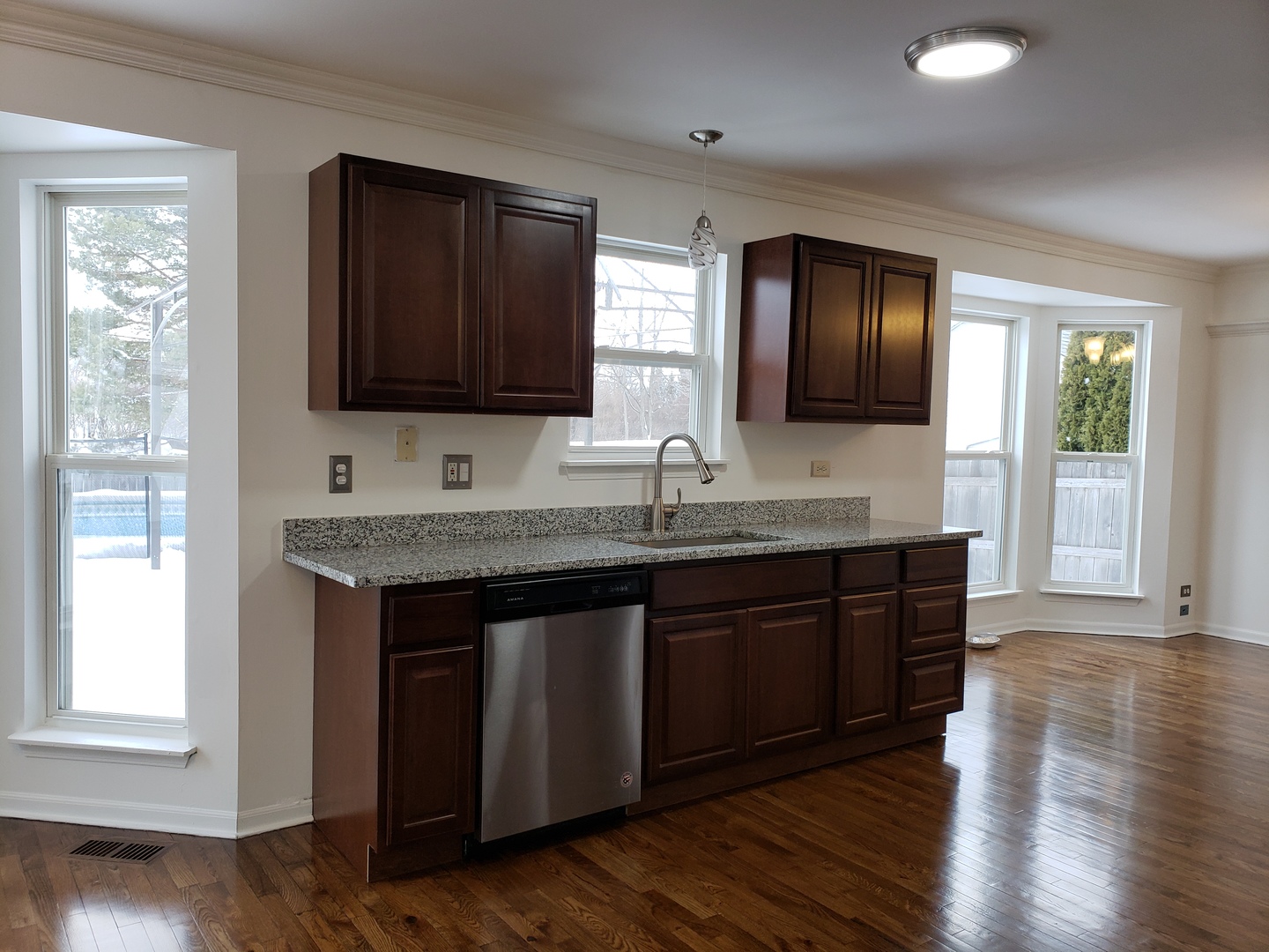 334 Spring Valley Way Round Lake, IL 60073 - Photo 7 of 26 a kitchen with granite countertop wooden cabinets a sink and a window