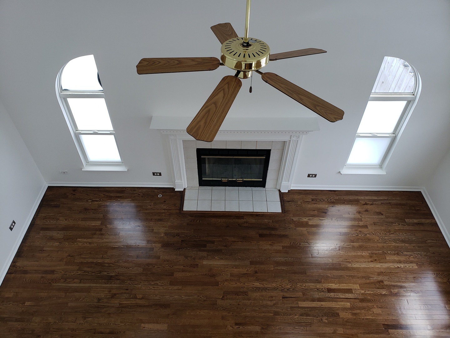 334 Spring Valley Way Round Lake, IL 60073 - Photo 9 of 26 a view of an empty room with wooden floor fireplace and a window