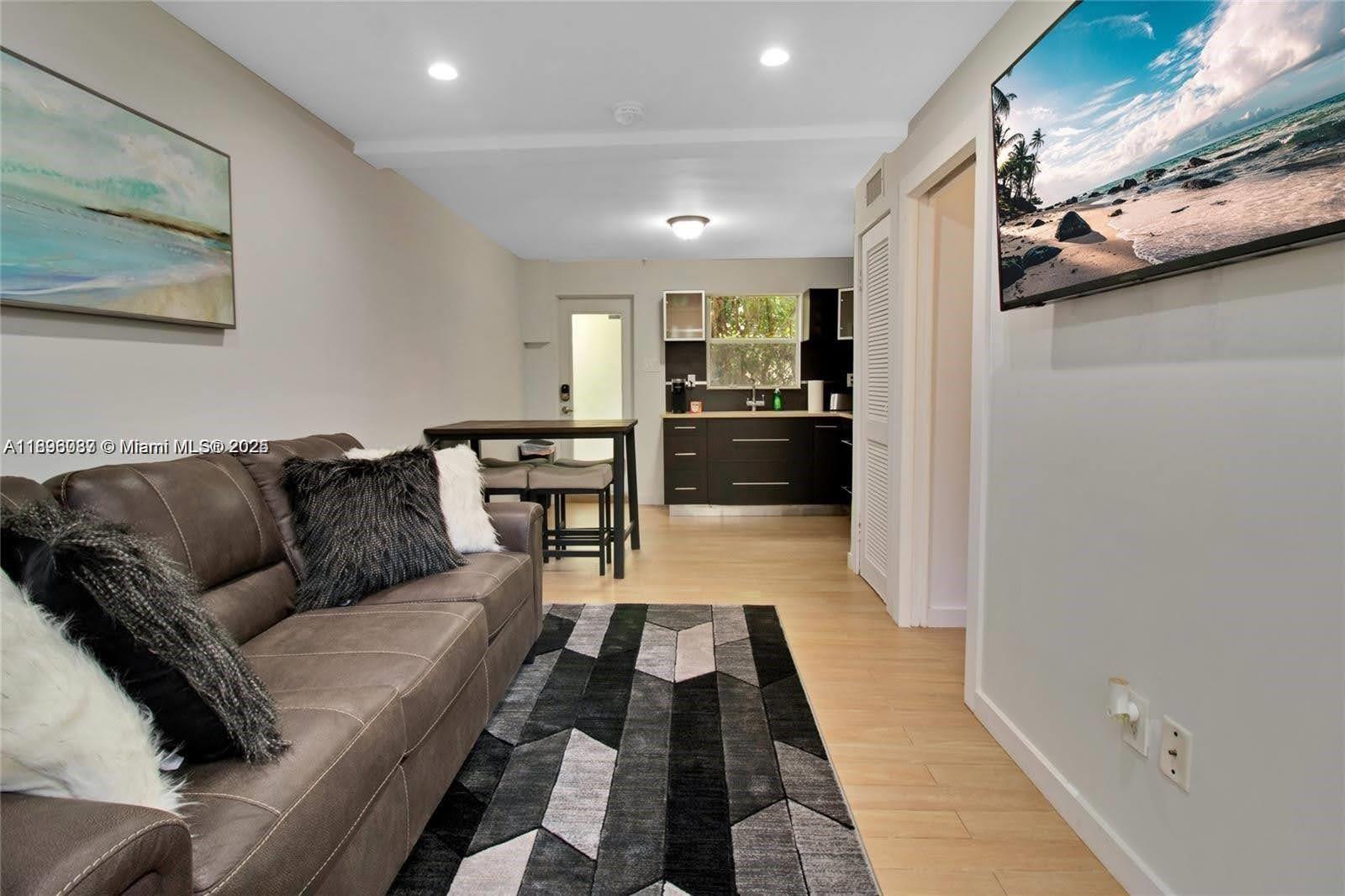 833 West 39th Street, Unit 5 Miami Beach, FL 33140 - Photo 4 of 12 a living room with furniture and a couch