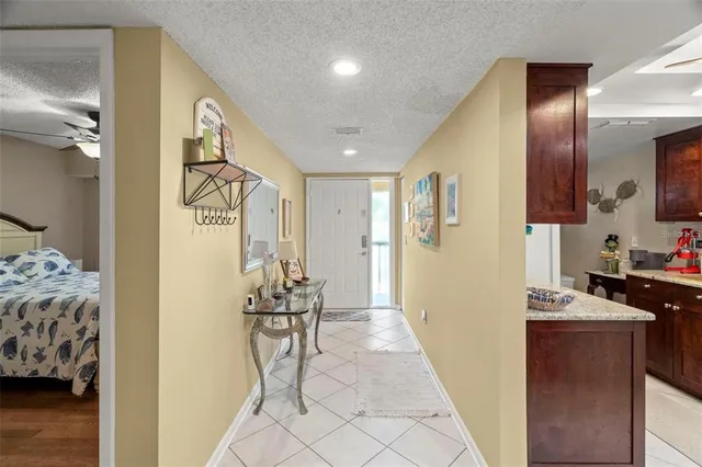 a view of a dining room and livingroom with furniture wooden floor a chandelier