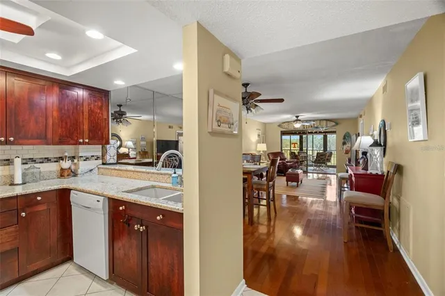 a kitchen with a sink cabinets and wooden floor
