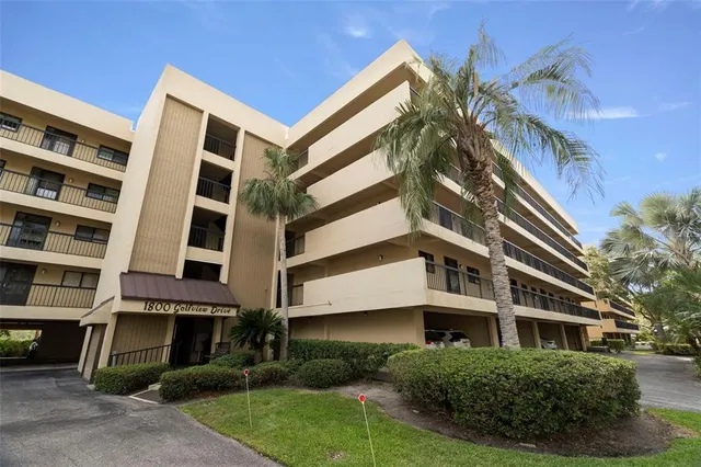 a view of a street with potted plants