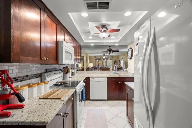 a kitchen with stainless steel appliances granite countertop lots of counter top space and cabinets