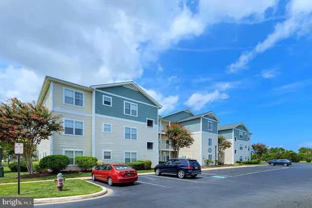 a car parked in front of a house with a cars parked