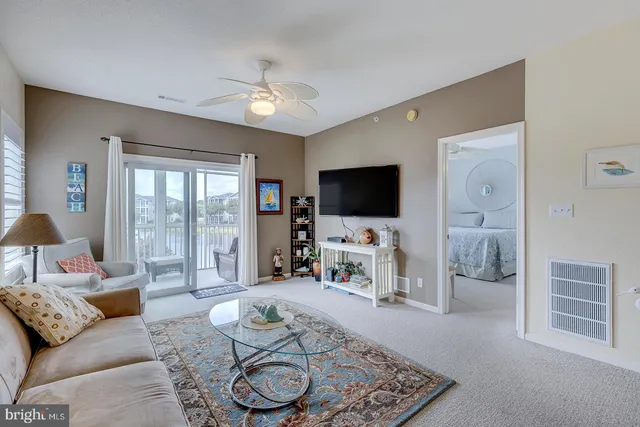a kitchen with stainless steel appliances kitchen island granite countertop a refrigerator and cabinets