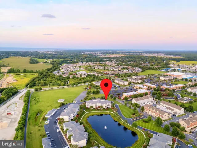 a living room with furniture a large window and wooden floor